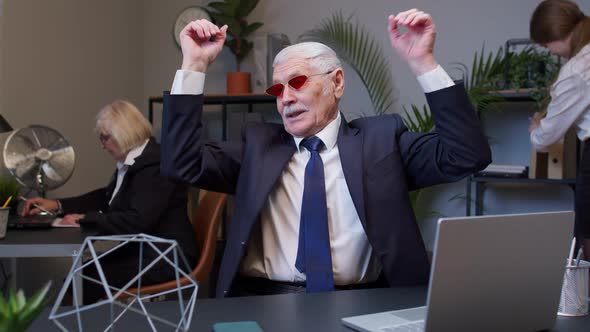Senior Old Businessman Dancing Celebrating Sudden Victory Wearing Sunglasses Waiting for Vacation