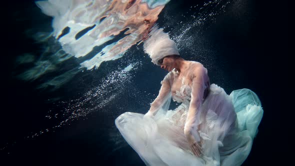 Fabulous Underwater Shot with Graceful Lady in Depth Mysterious Deepness