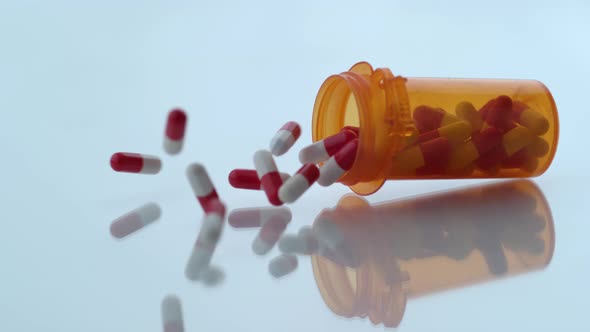 Pills spilling out of bottle in slow motion; shot on Phantom Flex 4K at 1000 fps alt