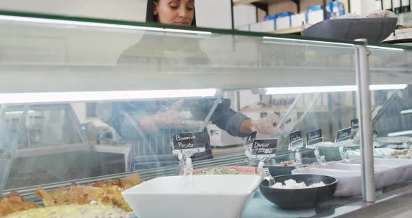 Animation of biracial waitress taking food from fridge