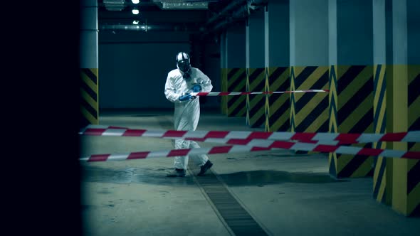 Coronavirus, Disinfection Concept. Sanitation Worker Is Stretching a Barrier Tape