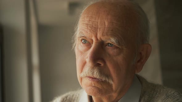 Pensive elderly senior man looking away feel upset