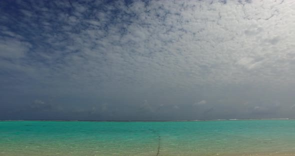 Luxury overhead abstract shot of a white sandy paradise beach and blue ocean background in vibrant 4