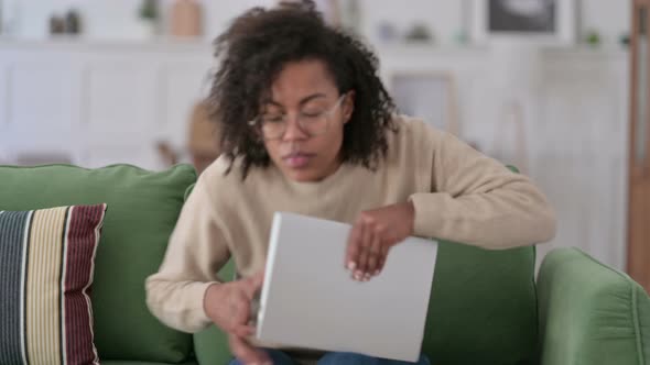 Young African Woman Closing Laptop Going Away From Sofa 