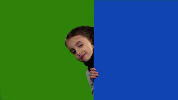 Child Looks Out From Behind an Empty Board, Green Screen,Slow Motion