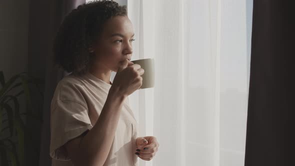 Biracial Girl Enjoying Morning Coffee at Home