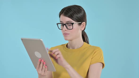 Professional Young Woman Working on Tablet on Purple Background