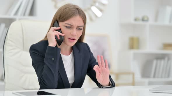 Angry Young Businesswoman Arguing on Smartphone 