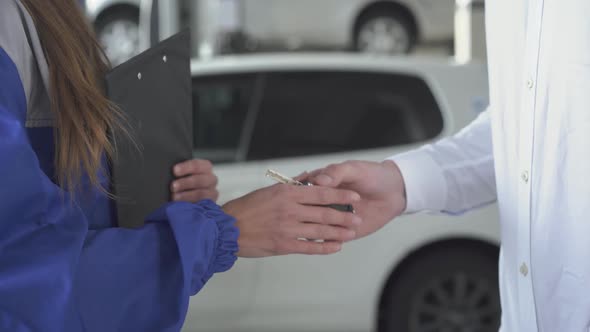 Female Automobile Specialist After Taking Datas About Car and Signed Taking Key and Shaking Hands