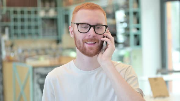 Portrait of Redhead Man Talking on Smartphone