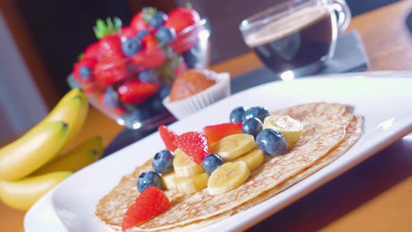 Tasty Breakfast of Pancakes and Fruit on the Table
