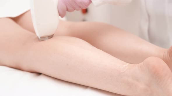 Flash of Diode Laser Hair Removal Beautician Removes Hair on Beautiful Female Legs Hair Removal for