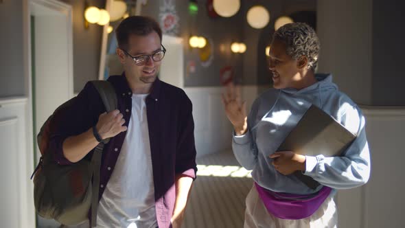 Happy Multiethnic Students Chatting Walking Inside College Building