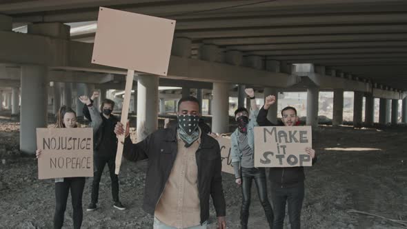 Protesters with Signs under Highway Bridge