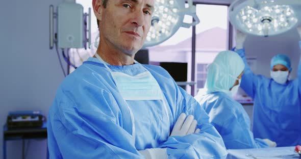 Close-up of mature Caucasian female doctor standing with arms crossed in hospital