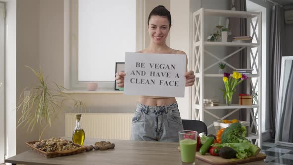 Happy Beautiful Positive Young Woman Showing Be Vegan and Have a Clean Face Smiling Looking at