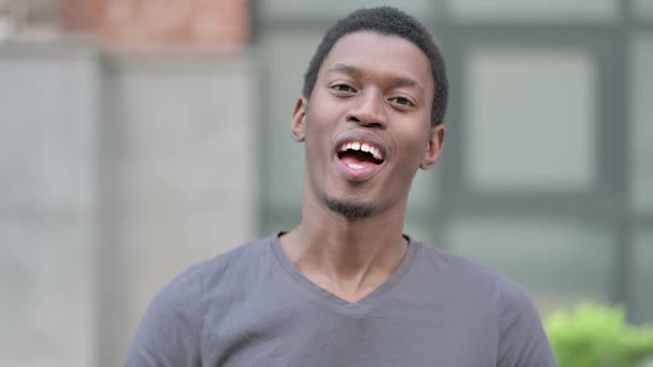 Portrait of Young Young African Man Talking on Video Call