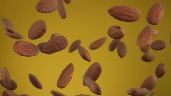 Close-up of Delicious Almonds Bouncing and Rotating on the Yellow Background