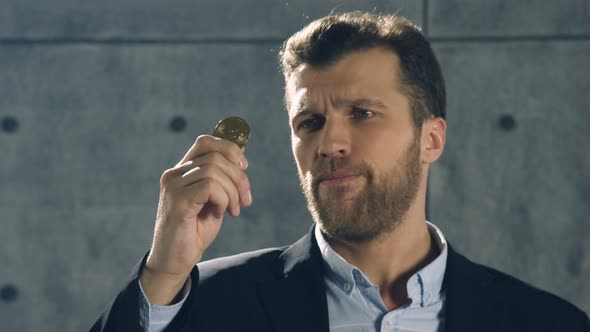 Portrait of Man Holding Bitcoin in His Hand and throw it out