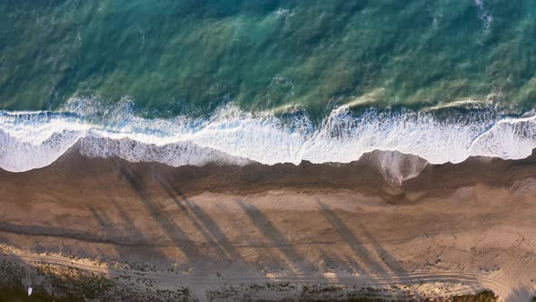 Aerial View of Ocean Waves on Sandy Beach