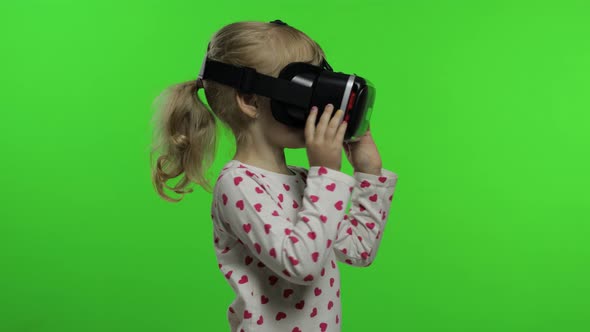 Child Girl Using VR Headset Helmet To Play Game. Watching Virtual Reality 3d 360 Video. Chroma Key