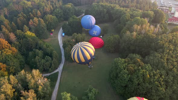 Aerial View of Hot Air Balloons Prepare for an Summer Early Morning Flying in Park in Small European