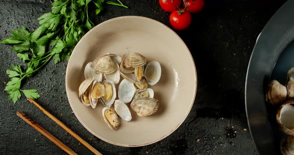 The Vongole Mussels Are Placed on a Plate From a Saucepan. 