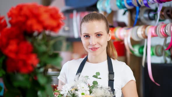 Portrait of Young Florist Female Beautiful Cheerful Woman Looks at the Camera and Smiles 