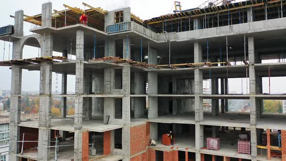 Building In The Process Of Construction. Construction site with bird eye in megacity