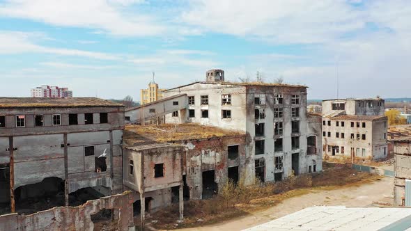 Aerial view of abandoned buildings, ruined after military actions.