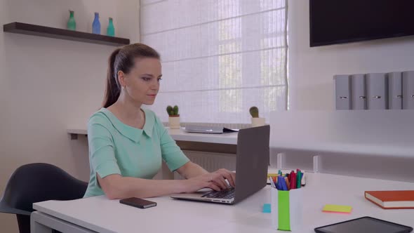 Businesswoman Typing Fast on Computer