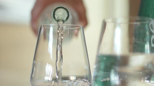 Drinking water pouring into a glass.