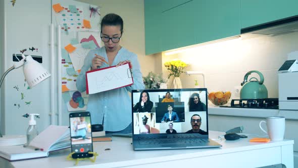 Female Specialist Is Filming Herself During an Online Meeting. Group of Colleagues Talking Using