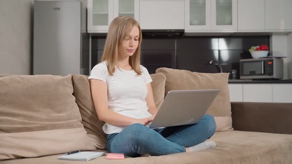 Charming Woman Typing Laptop Couch