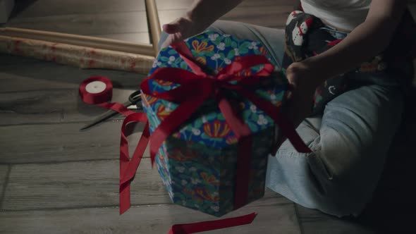 Woman Packing Xmas Fancy Gift at Home