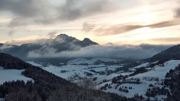 Mountain winter landscape, the sun shines through the clouds,Golden hour