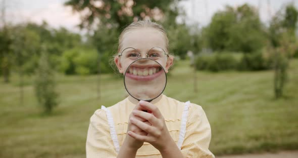 Loupe Fun Children Smile with a Magnifying Glass Enjoy He Makes Big Teeth