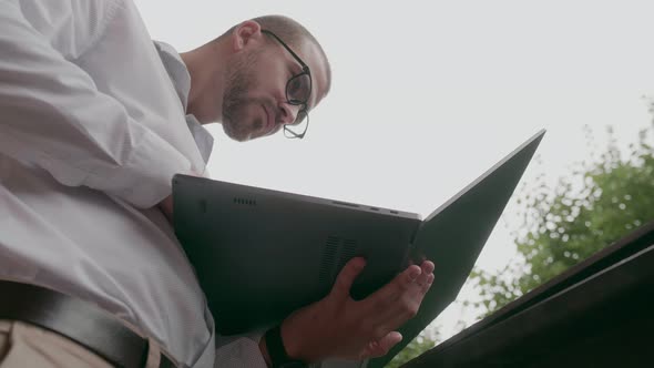 Businessman with Laptop on the Street