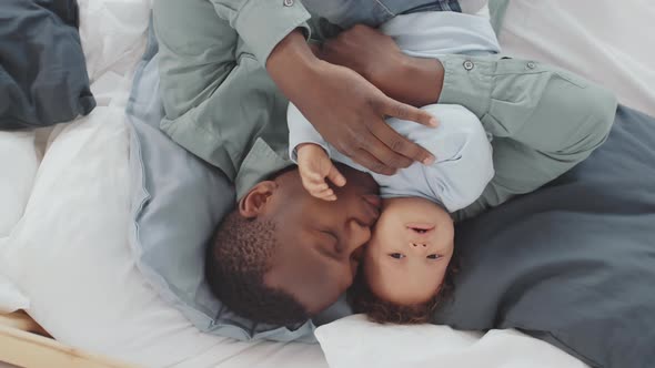 Father and Little Kid Lying in Bed