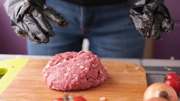 Woman Beats Minced Meat for Cooking Cutlets on Wooden Cutting Board