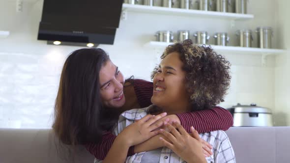 Girlfriend Asian Hugs Her AfricanAmerican Girlfriend From Behind