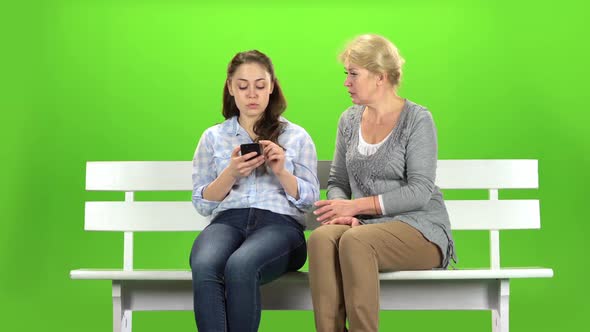 Girl Shows Something in the Phone To Her Mother. Green Screen