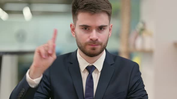 Young Businessman Saying No By Finger Sign