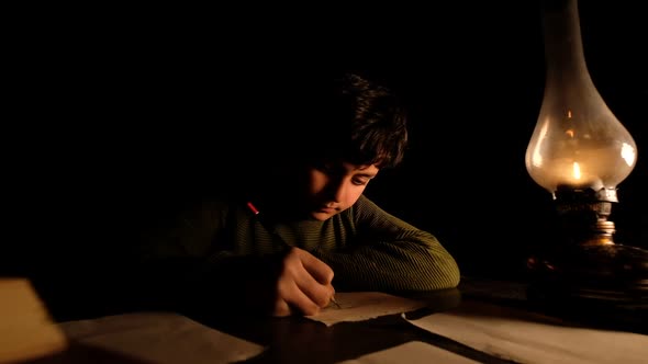 A Child Studying At Night
