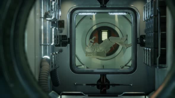 Astronaut Inside the Orbital Space Station alt