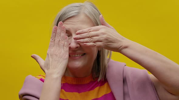 Face Of Elderly Woman In Sportswear On Yellow Background