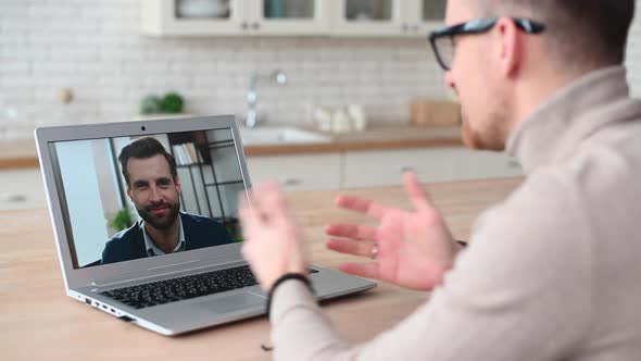 Happy Fit Young Bearded Hipster Man in Glasses Has Video Call