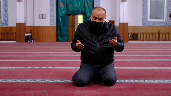 Masked man praying mosque