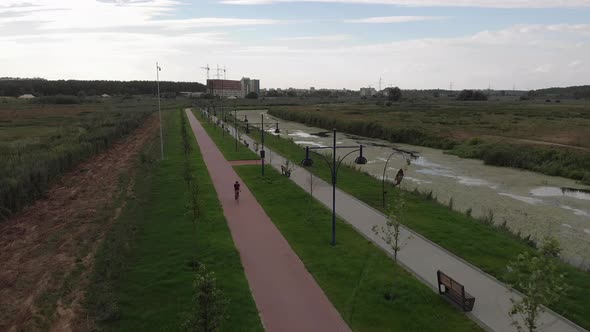 Professional female cyclist is riding fast on bicycle on cycle path. Cycling concept