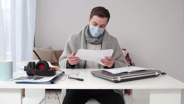 Young Businessman Working at Home with Face Mask